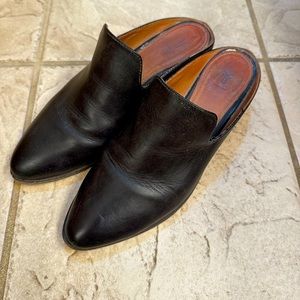 Worn Frye black mules.